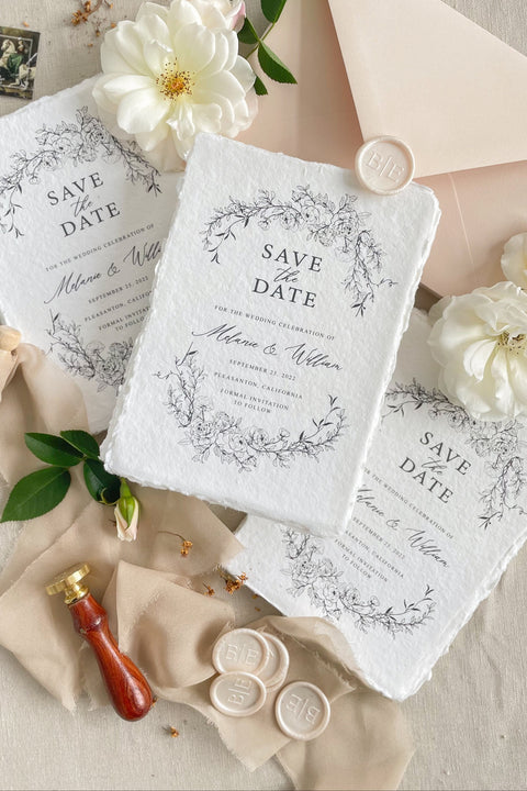 Announce your wedding with timeless elegance through our handmade paper Save the Date cards, beautifully printed on luxury 100% cotton handmade paper with natural deckled edges and a delicate botanical wreath illustration. Each piece embodies fine-art romance - soft, organic, and intentionally crafted to set the tone for an unforgettable celebration.