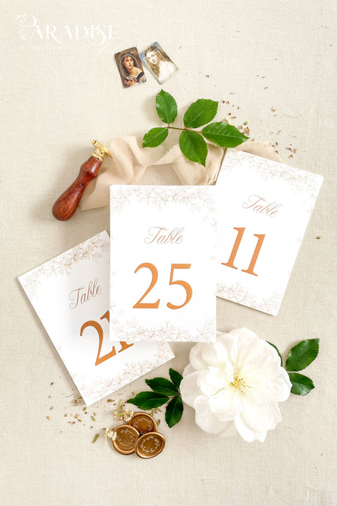 Clean white cardstock paired with rich copper typography creates a beautifully modern yet romantic table number design. Delicate botanical borders add a soft, ornamental touch, giving each card a refined and cohesive wedding-day presence. Perfect for elegant, garden, rustic-chic, or contemporary celebrations, this style blends minimalist clarity with decorative charm.