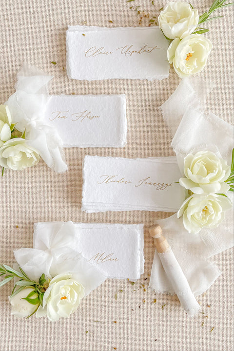 Create a romantic, fine-art tablescape with our handmade paper place cards, crafted from luxurious cotton rag paper and finished with soft, torn deckled edges. Each card features elegant calligraphy, delicate chiffon ribbon, and a timeless organic texture - perfect for weddings, intimate dinners, bridal showers, or upscale celebrations. These artisan-crafted pieces bring softness, refinement, and natural beauty to any seating display.