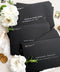 Premium black envelopes with crisp white ink printing, styled for luxury weddings with floral accents and clean, modern presentation.