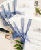 Hand-drawn venue artwork meets fine-art craftsmanship in these beautifully assembled wedding programs. The soft blue ribbon, textured cotton paper, and delicate illustration create an heirloom-quality piece that sets the tone for a romantic, detail-rich ceremony. Each program balances sophistication with warmth, offering guests a meaningful preview of your celebration.
