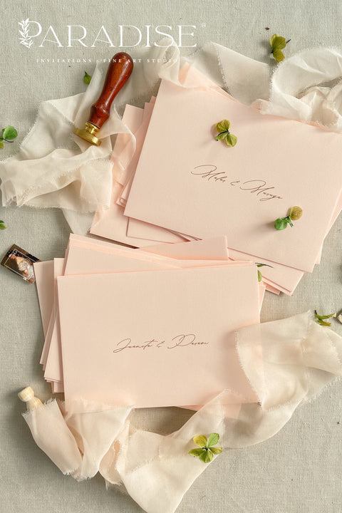 Blush wedding envelopes with professional address printing, crafted from premium paper and arranged to show soft color, smooth texture, and refined typography.