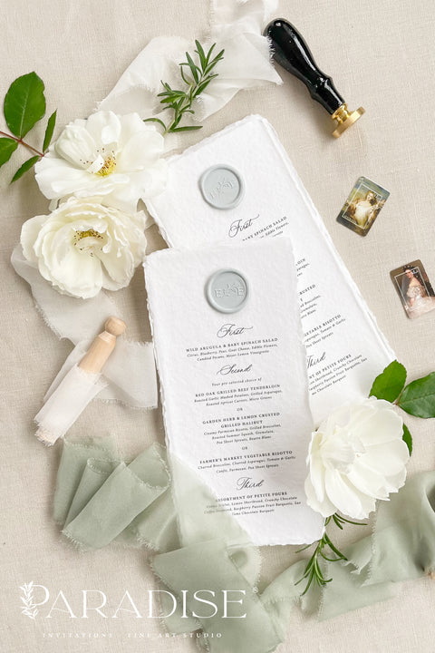 These handmade paper wedding menus exude timeless refinement and artisanal charm, designed to bring a touch of romance to your wedding tablescape. Each menu is crafted from luxurious 100% cotton rag paper, known for its soft texture and naturally deckled edges, offering an organic yet elegant finish. The menus feature classic black typography paired with a custom wax seal in soft gray, perfectly balancing simplicity and sophistication.