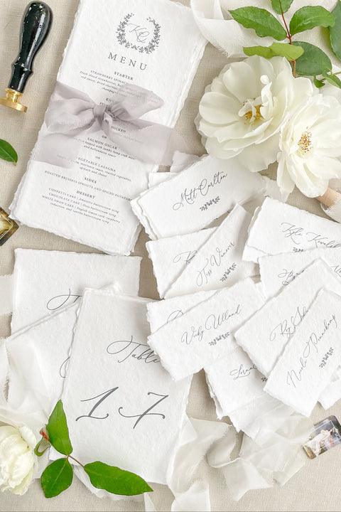 Bring timeless elegance to your event with our handmade paper place cards, crafted from luxurious cotton rag paper and finished with naturally torn deckled edges. Each name tag features refined calligraphy and a soft fine-art aesthetic, making them perfect for weddings, rehearsal dinners, intimate gatherings, and upscale celebrations. These artisan-crafted cards add texture, beauty, and sophistication to any seating display or tablescape.
