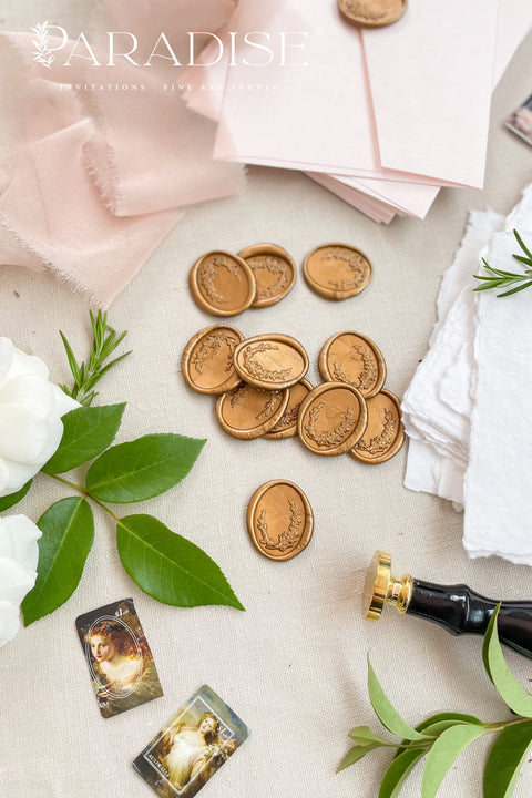 Hand-poured golden wax seals add a timeless, heirloom finish to wedding invitations, envelopes, and luxury paper goods. Each seal is individually crafted to bring warmth, depth, and an elegant metallic glow to your stationery suite - perfect for couples seeking refined, old-world detail with a modern touch. Designed to complement handmade paper, soft ribbons, and calligraphy, these wax seals elevate every envelope into a keepsake-worthy detail.