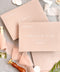 Soft birch envelopes featuring white ink calligraphy address printing, photographed with wax seals and styling props for elegant wedding stationery.