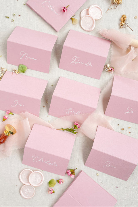 Add a modern pop of color to your event with our colored paper place cards, crafted from premium heavyweight cardstock and folded for a polished, freestanding design. Each card features elegant calligraphy in a soft contrasting tone, making them perfect for weddings, bridal showers, birthdays, baby showers, and stylish celebrations. These vibrant place cards bring personality, charm, and a refined touch to your tablescape while remaining beautifully cohesive with contemporary event aesthetics.