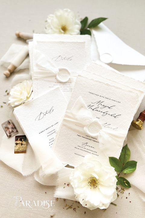 Elegant, refined, and crafted by hand - our handmade wedding invitation suite captures the essence of modern romance. Printed on 100% cotton deckled-edge paper, each invitation is delicately tied with an ivory chiffon ribbon and sealed with a white wax monogram, creating an heirloom piece that feels soft, timeless, and beautifully personal.