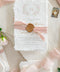 Announce your special day with the delicate, romantic charm of these handmade wedding invites. Perfect for a summer wedding, this suite features a soft and beautiful dusty pink color palette and delicate floral artwork. Each invitation is individually crafted, giving it a unique, tactile feel that you and your guests will appreciate. The combination of handcrafted artistry and a fresh, romantic design sets a beautiful tone for your celebration.