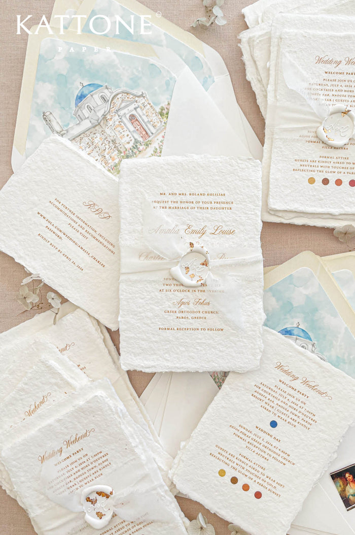 Luxury handmade cotton paper wedding invitation with deckled edges and gold typography, styled with wax seal, vellum wrap and watercolor Greek church envelope liners.