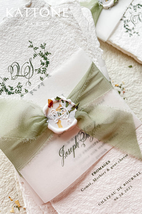These handmade paper wedding menus are the epitome of timeless elegance and refined craftsmanship. Made from 100% cotton rag paper, each piece features a beautifully textured surface and natural deckled edges, exuding the charm of fine art stationery. The menu design showcases a botanical-inspired monogram delicately printed in deep green ink, creating a harmonious blend of organic beauty and understated luxury.