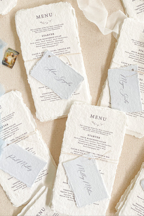 Bring timeless elegance to your wedding reception with our handmade paper wedding menus, beautifully crafted from 100% cotton rag paper with naturally torn deckled edges. Each menu is a piece of art - refined, tactile, and designed to elevate your table styling with understated luxury. Featuring elegant typography and paired with delicate personalized name tags.