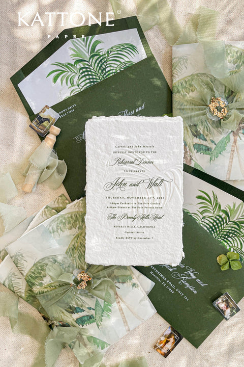 This embossed handmade paper wedding invitation suite was designed for couples who adore refined botanical beauty and modern sophistication. Printed on luxury deckled-edge cotton paper, each invitation features an elegant embossed palm motif, adding a tactile dimension that captures both light and texture beautifully. The design is complemented by deep green envelopes with palm illustrations and vellum jackets adorned with lush botanical artwork.