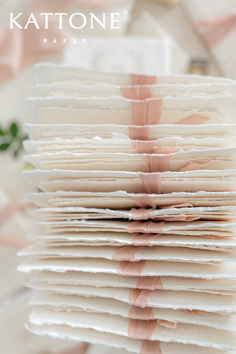 Announce your special day with the delicate, romantic charm of these handmade wedding invites. Perfect for a summer wedding, this suite features a soft and beautiful dusty pink color palette and delicate floral artwork. Each invitation is individually crafted, giving it a unique, tactile feel that you and your guests will appreciate. The combination of handcrafted artistry and a fresh, romantic design sets a beautiful tone for your celebration.