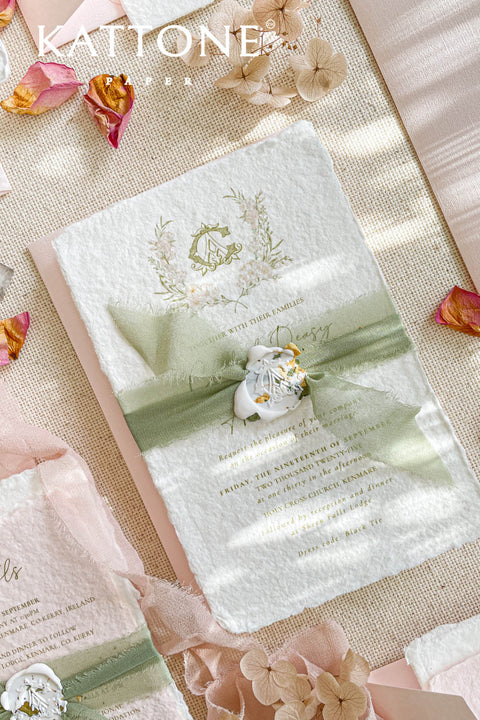Elevate your wedding announcement with this exquisite invitation suite, meticulously crafted for a truly memorable impression. This set combines the luxurious, textured feel of handmade paper with the sophisticated details of premium silk ribbons and personalized wax seals. The entire suite is elegantly enclosed in beautiful coco linen petite pink envelopes, adding a final touch of charm and romance that your guests will adore from the moment they open their mail.