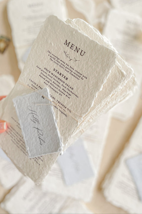 Bring timeless elegance to your wedding reception with our handmade paper wedding menus, beautifully crafted from 100% cotton rag paper with naturally torn deckled edges. Each menu is a piece of art - refined, tactile, and designed to elevate your table styling with understated luxury. Featuring elegant typography and paired with delicate personalized name tags.