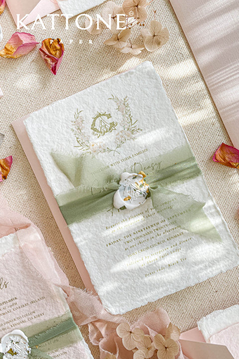 Elevate your wedding announcement with this exquisite invitation suite, meticulously crafted for a truly memorable impression. This set combines the luxurious, textured feel of handmade paper with the sophisticated details of premium silk ribbons and personalized wax seals. The entire suite is elegantly enclosed in beautiful coco linen petite pink envelopes, adding a final touch of charm and romance that your guests will adore from the moment they open their mail.