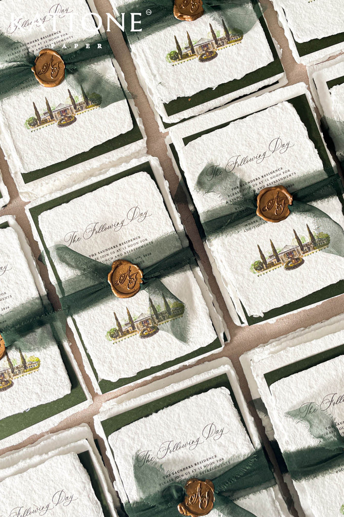 Premium wedding invitation suite with botanical crest artwork, deckled paper, vellum wraps, chiffon ribbon, and elegant green luxury styling.