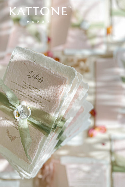Elevate your wedding announcement with this exquisite invitation suite, meticulously crafted for a truly memorable impression. This set combines the luxurious, textured feel of handmade paper with the sophisticated details of premium silk ribbons and personalized wax seals. The entire suite is elegantly enclosed in beautiful coco linen petite pink envelopes, adding a final touch of charm and romance that your guests will adore from the moment they open their mail.