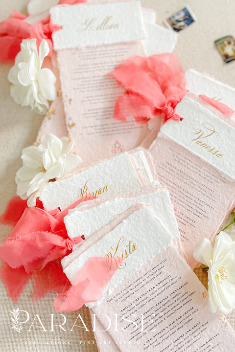Bring a burst of color and elegance to your table setting with our colored handmade paper wedding menus, crafted from luxurious 100% cotton rag paper. These exquisite menus feature soft blush-pink tones, deckled edges, and gold foil calligraphy, creating a romantic and elevated aesthetic for any celebration. Each menu is finished with a vibrant coral silk ribbon and personalized name tag, combining artistry and function by doubling as both a menu and a place card. 
