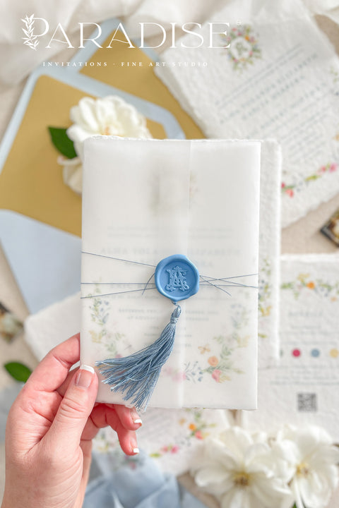 This exquisite wedding invitation set offers a blend of timeless charm and whimsical artistry. Each suite is printed on a luxurious handmade paper from our cotton rag suite, providing a rich, tactile feel. A delicate tassel is included with each invite, adding a playful pop of color and charm. The beautiful watercolor floral invites create a stunning and romantic preview of your special day.
