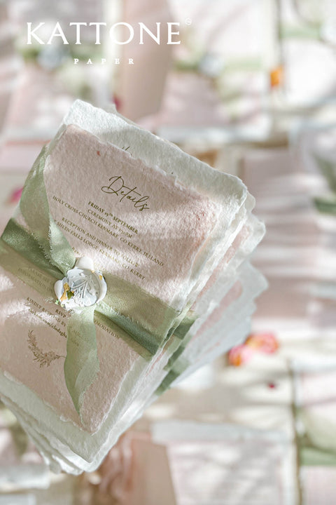 Elevate your wedding announcement with this exquisite invitation suite, meticulously crafted for a truly memorable impression. This set combines the luxurious, textured feel of handmade paper with the sophisticated details of premium silk ribbons and personalized wax seals. The entire suite is elegantly enclosed in beautiful coco linen petite pink envelopes, adding a final touch of charm and romance that your guests will adore from the moment they open their mail.