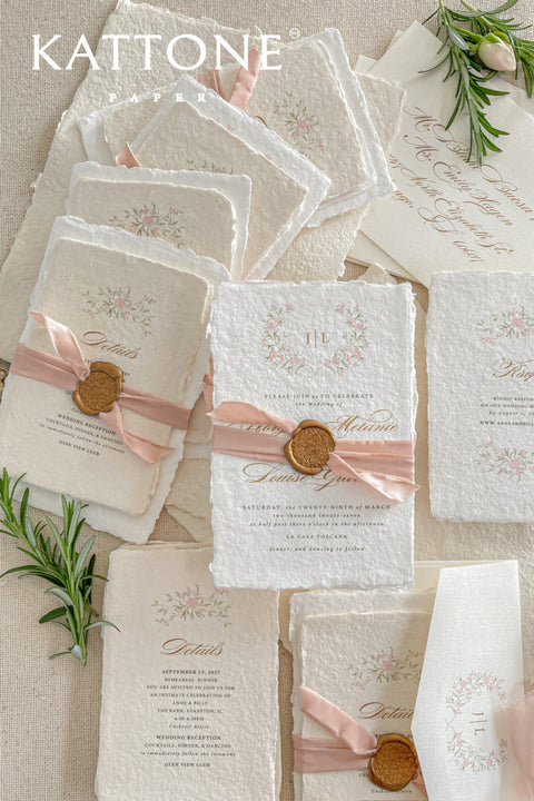 Announce your special day with the delicate, romantic charm of these handmade wedding invites. Perfect for a summer wedding, this suite features a soft and beautiful dusty pink color palette and delicate floral artwork. Each invitation is individually crafted, giving it a unique, tactile feel that you and your guests will appreciate. The combination of handcrafted artistry and a fresh, romantic design sets a beautiful tone for your celebration.