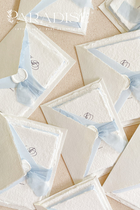 Announce your special day with a touch of coastal elegance and bohemian chic with this unique beach wedding invitations suite. Perfect for a seaside celebration, this elegant wedding stationery set combines classic details with a relaxed feel. Each invite is finished with a personalized wax seal, adding a luxurious, tactile element that makes a memorable first impression.