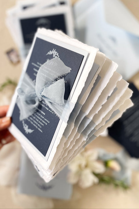 Elegant, timeless, and entirely handmade - this blue fine art wedding invitation suite was created for couples who want their stationery to feel as meaningful and beautiful as their love story. Each invitation is printed on luxurious deckled-edge cotton paper, hand-torn for that soft, organic texture, and wrapped in a dusty blue chiffon ribbon that adds a romantic finishing touch.