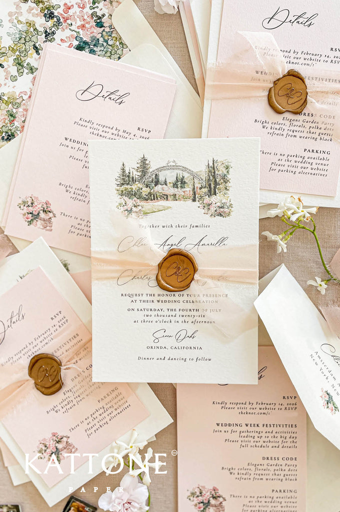Close-up of handmade paper wedding invitation featuring a watercolor illustration of a garden wedding venue and elegant typography.