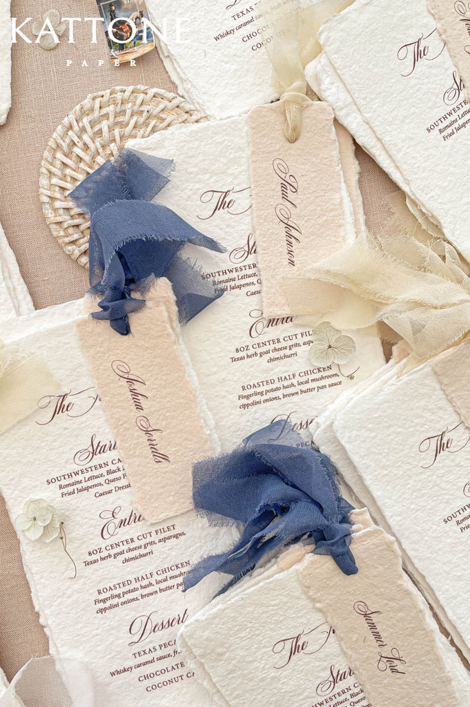 Premium wedding reception menu suite designed with deckled edge cotton paper, personalized name tags, and elegant editorial styling.