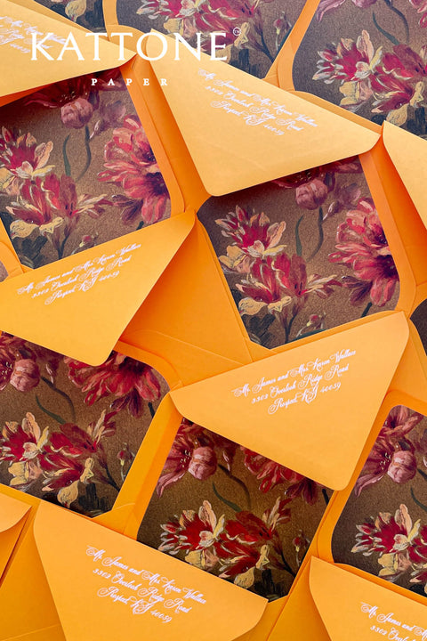 Close-up of floral envelope liner inside terracotta envelope showing painterly blooms, rich colors, and smooth premium paper texture.