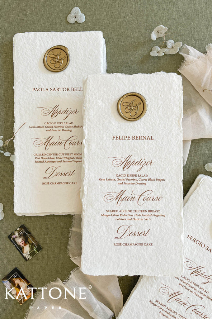 Gold wax seal placed at the top of handmade wedding menu adding a classic and luxurious detail.