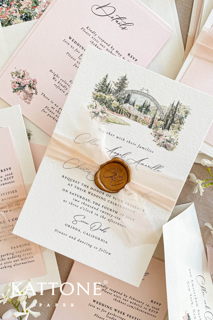 Close-up of handmade paper wedding invitation featuring a watercolor illustration of a garden wedding venue and elegant typography.