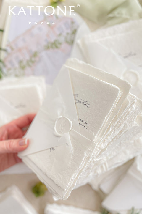 Introduce your wedding with the timeless and intimate feel of the Romantic Handmade Wedding Invitation. Each invite is a beautiful work of fine art, crafted on luxurious, artisan handmade paper with a natural deckle edge, giving it an organic, delicate texture that your guests will love to touch. The combination of handcrafted paper and a personalized, romantic design creates a bespoke feel that sets a deeply meaningful tone for your celebration.