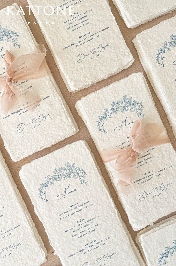 Luxury wedding menu stationery featuring delicate blue botanical floral illustrations for a timeless romantic aesthetic.
