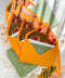 Terracotta wedding envelopes with floral envelope liners styled with handmade paper, greenery, and fine art wedding stationery details.