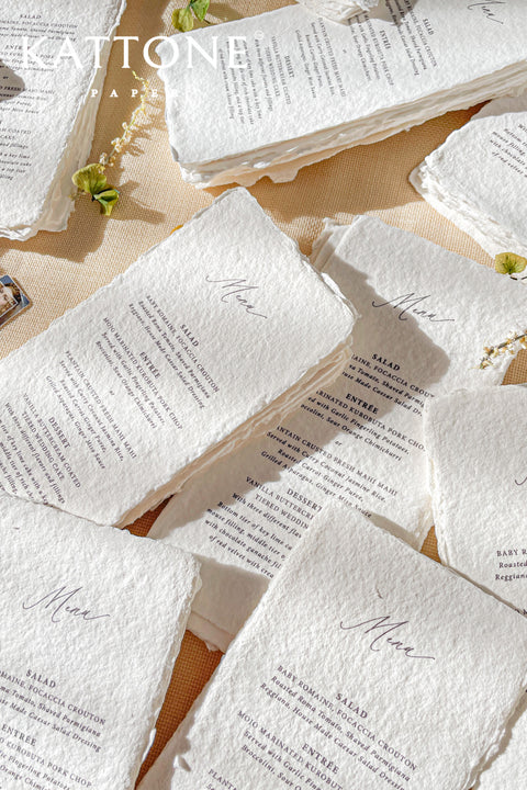 Elevate your tablescape with our handmade paper wedding menus, meticulously crafted from luxury cotton paper with naturally torn deckled edges. Each piece exudes timeless refinement - perfect for romantic, fine-art, or destination weddings. Featuring minimalist typography and soft organic texture, these menus create a cohesive, elegant setting that beautifully complements your stationery suite and enhances your guests’ dining experience.