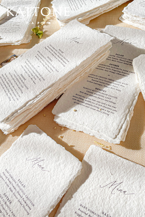 Elevate your tablescape with our handmade paper wedding menus, meticulously crafted from luxury cotton paper with naturally torn deckled edges. Each piece exudes timeless refinement - perfect for romantic, fine-art, or destination weddings. Featuring minimalist typography and soft organic texture, these menus create a cohesive, elegant setting that beautifully complements your stationery suite and enhances your guests’ dining experience.