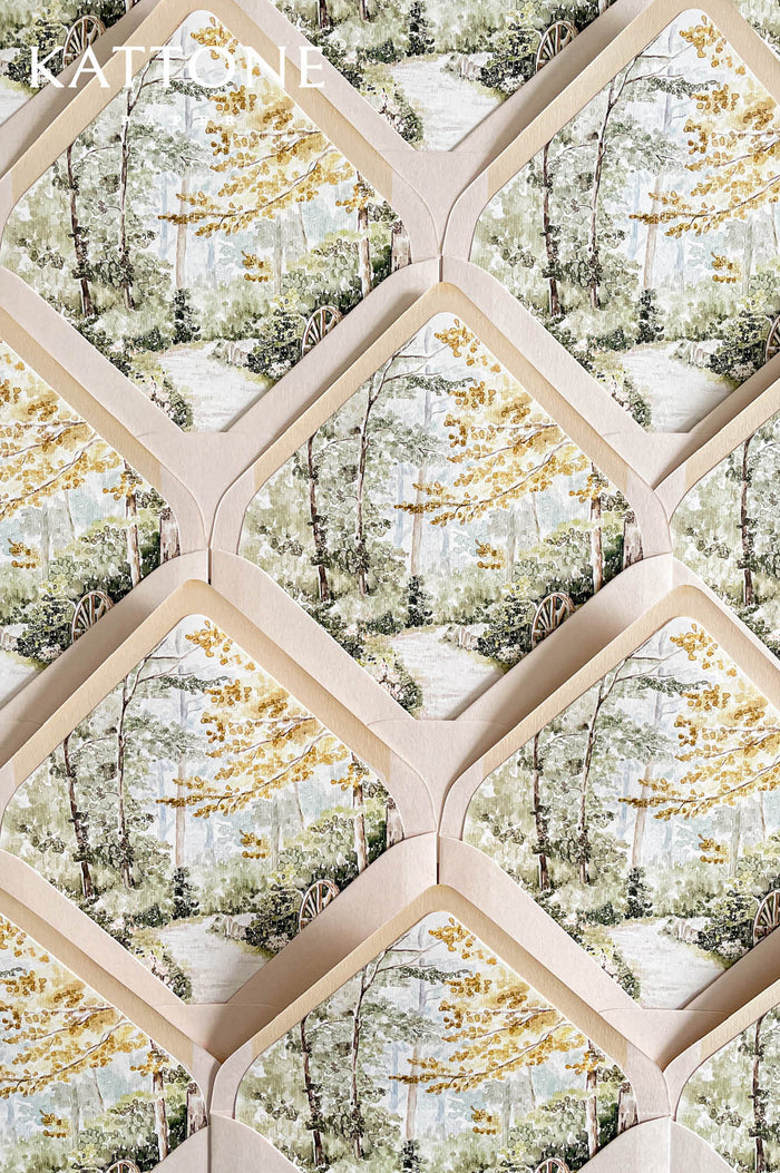 Luxury wedding envelopes with custom watercolor garden liners featuring soft landscape artwork in delicate green, cream, and muted golden tones.