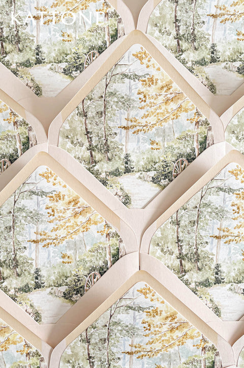 Custom wedding envelope liners with romantic watercolor garden illustration featuring soft greenery, trees, and golden foliage accents.