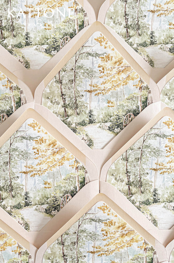 Custom wedding envelope liners with romantic watercolor garden illustration featuring soft greenery, trees, and golden foliage accents.