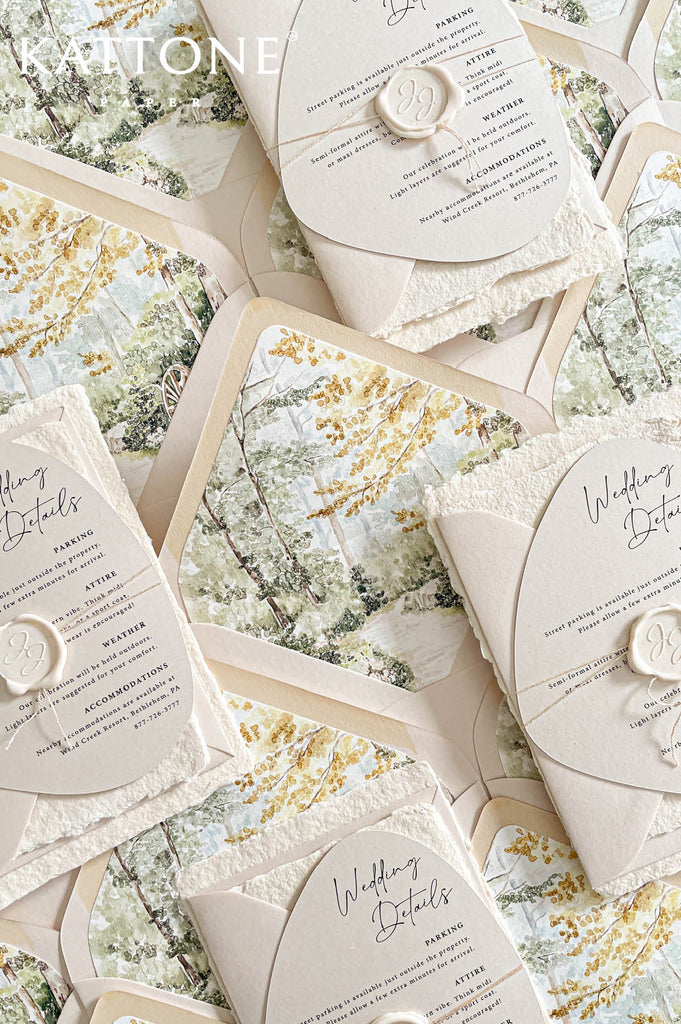 Soft neutral envelopes paired with scenic liner artwork create an elegant and cohesive layered stationery presentation.