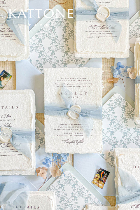 Collection of wedding invitations and stationery items, assembled with silk ribbons and wax seals. envelope liners. Elevate your special day with our Briseis Handmade Paper Wedding Invites. Crafted with love and attention to detail, these elegant invitations blend rustic charm with modern design. Each piece is made from eco-friendly materials, ensuring a unique touch for your celebration. Perfect for intimate gatherings or grand affairs, our invites set the tone for your wedding. 