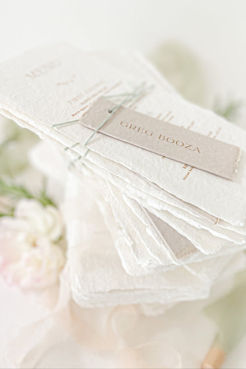 Add refined sophistication to your tablescape with our handmade paper wedding menus with personalized name tags - a perfect fusion of artisanal texture and elegant design. Each piece is hand-torn from luxury cotton paper, featuring deckled edges, fine typography, and customizable tags tied with delicate thread. These menus create a cohesive, fine-art look while doubling as elegant place cards for your guests.
