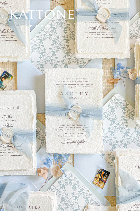 Collection of wedding invitations and stationery items, assembled with silk ribbons and wax seals. envelope liners. Elevate your special day with our Briseis Handmade Paper Wedding Invites. Crafted with love and attention to detail, these elegant invitations blend rustic charm with modern design. Each piece is made from eco-friendly materials, ensuring a unique touch for your celebration. Perfect for intimate gatherings or grand affairs, our invites set the tone for your wedding. 