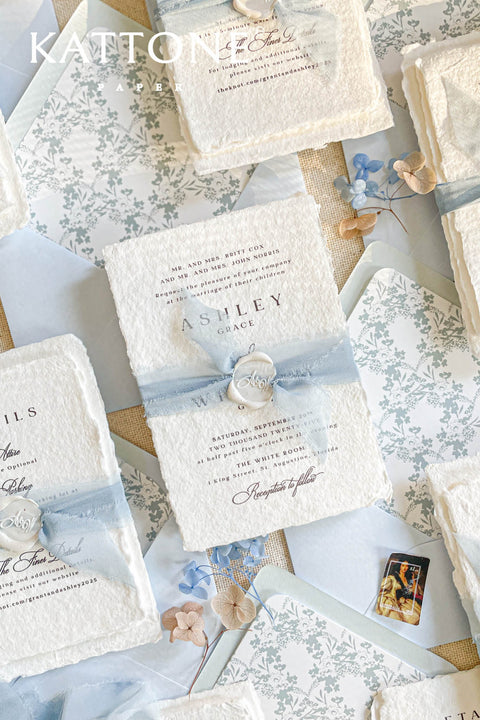 Collection of wedding invitations and stationery items, assembled with silk ribbons and wax seals. envelope liners. Elevate your special day with our Briseis Handmade Paper Wedding Invites. Crafted with love and attention to detail, these elegant invitations blend rustic charm with modern design. Each piece is made from eco-friendly materials, ensuring a unique touch for your celebration. Perfect for intimate gatherings or grand affairs, our invites set the tone for your wedding. 