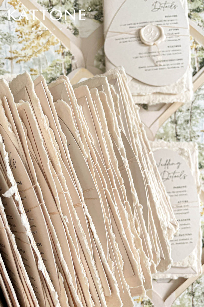 Elegant handmade paper wedding invitation with deckled edges featuring refined typography and timeless minimalist styling for a romantic luxury wedding aesthetic.