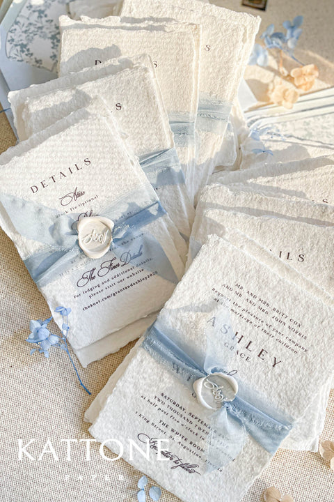 Collection of wedding invitations and stationery items, assembled with silk ribbons and wax seals. envelope liners. Elevate your special day with our Briseis Handmade Paper Wedding Invites. Crafted with love and attention to detail, these elegant invitations blend rustic charm with modern design. Each piece is made from eco-friendly materials, ensuring a unique touch for your celebration. Perfect for intimate gatherings or grand affairs, our invites set the tone for your wedding. 