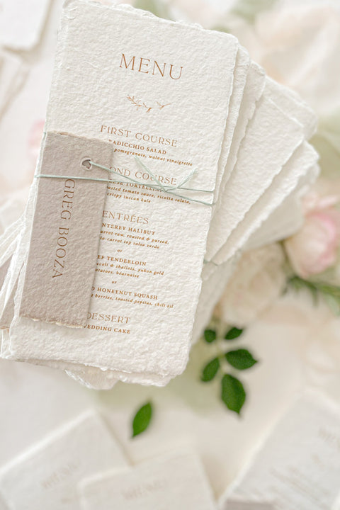Add refined sophistication to your tablescape with our handmade paper wedding menus with personalized name tags - a perfect fusion of artisanal texture and elegant design. Each piece is hand-torn from luxury cotton paper, featuring deckled edges, fine typography, and customizable tags tied with delicate thread. These menus create a cohesive, fine-art look while doubling as elegant place cards for your guests.